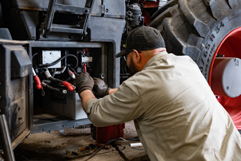 Man working on tractor parts